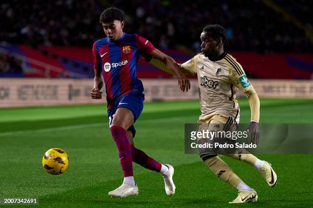 Lamine Yamal of FC Barcelona competes for the ball with Faitout Maouassa of Granada CF during the LaLiga EA Sports match between FC Barcelona and...