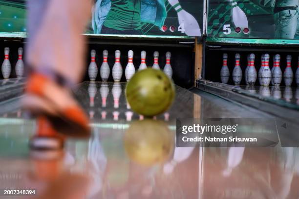 young woman in club for bowling is throwing ball - cream colored pants stock pictures, royalty-free photos & images