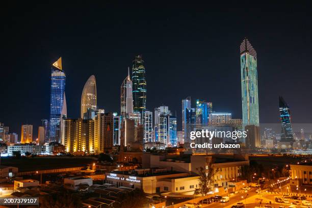 panoramic view of kuwait city skyline at night - royal blue stock pictures, royalty-free photos & images