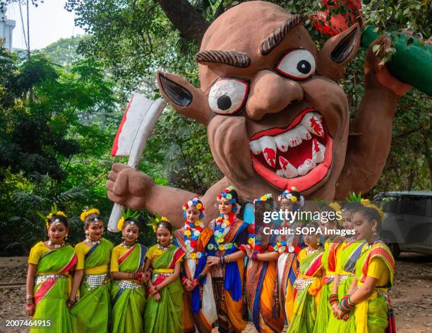 Children participants pose for a picture as they join the celebrations of the spring festival 'Basanta Utsav' at the Faculty of Fine Arts of the...