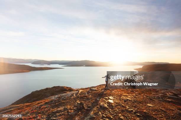 woman enjoys the norwegian countryside - moskenesoya stock pictures, royalty-free photos & images