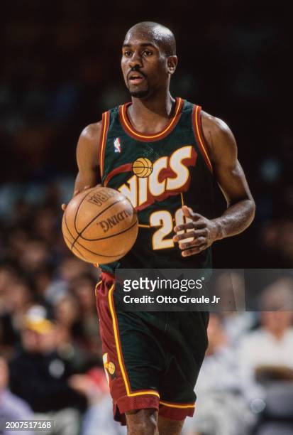 Gary Payton, Point Guard for the Seattle SuperSonics in motion dribbling the basketball down court during the NBA Pre Season basketball game against...