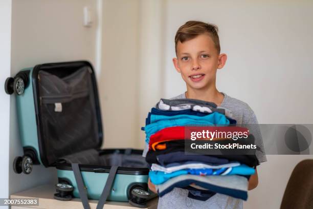 the boy is packing to go home - teen packing suitcase stock pictures, royalty-free photos & images