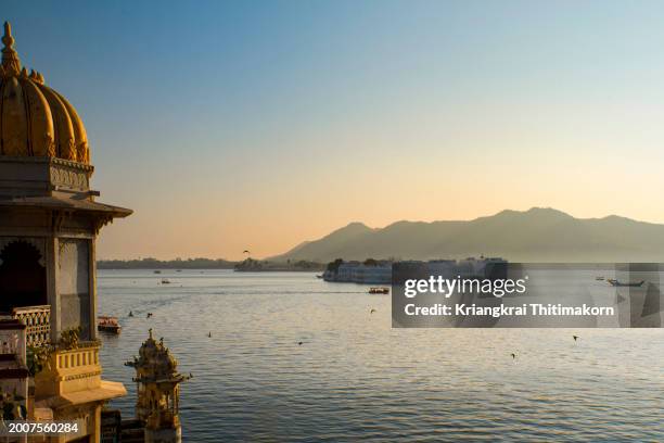view of lake phicola and taj lake palace. - udaipur stock pictures, royalty-free photos & images