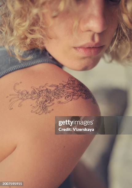 female shoulder with pen drawing - tattoo shoulder stock pictures, royalty-free photos & images