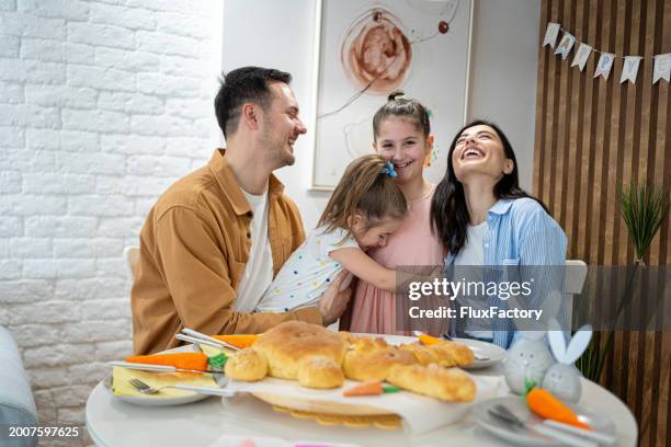 portrait of an young caucasian family during an easter lunch celebration - family rabbit stock pictures, royalty-free photos & images