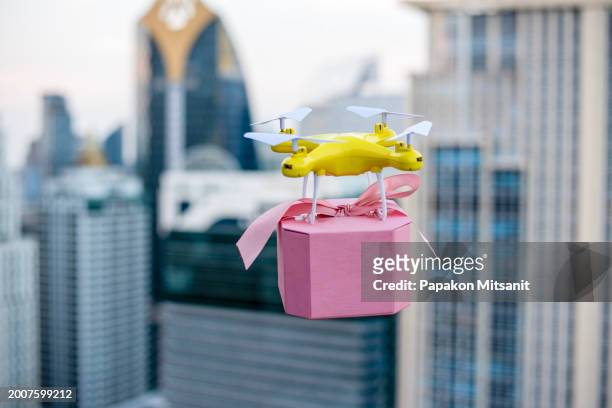 modern delivery is the use of delivery drones to deliver goods between high-rise buildings. - boxing ring empty stock pictures, royalty-free photos & images