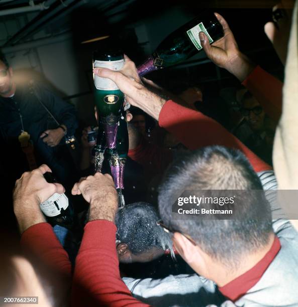 The St Louis Cardinals' Lou Brock is doused with champagne after the 7th and final game of the 1967 World Series against the Boston Red Sox, October...