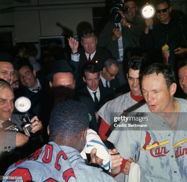 The St Louis Cardinals' Lou Brock is doused with champagne after the 7th and final game of the 1967 World Series against the Boston Red Sox, October...