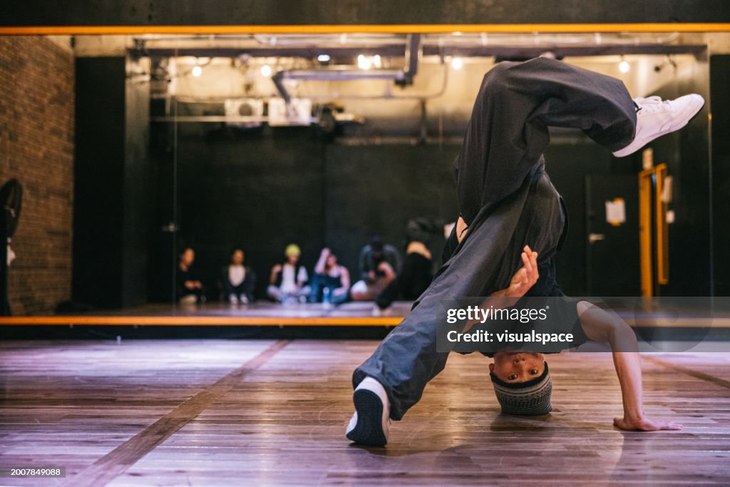 Japanese man showing hip hop dance moves in a dance studio