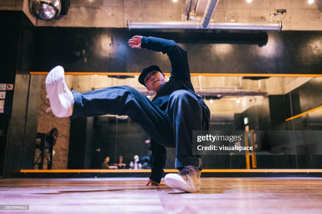 Young Japanese woman doing a hip hop pose for the camera