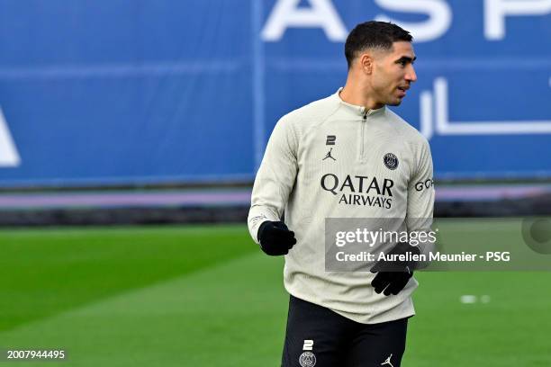 Achraf Hakimi of Paris Saint-Germain looks on during a training session prior the UEFA Champions League 2023/24 round of 16 first leg match against...