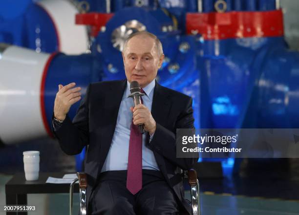 Russian President Vladimir Putin attends a meeting with workers at the AO Konar plant, a few minutes after his spokesman Dmitry Peskov said that...