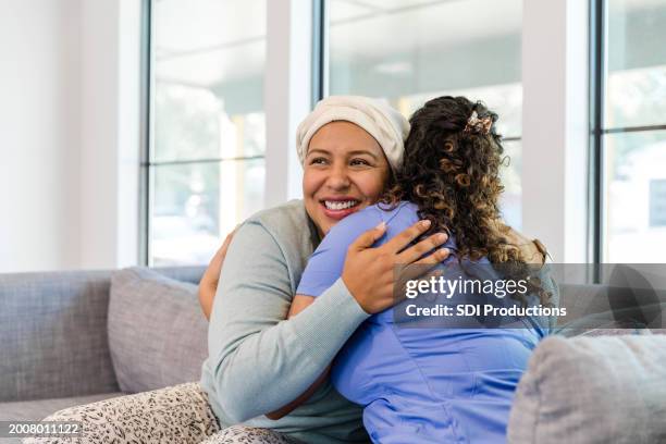 unrecognizable female nurse hugs her patient - oncology stock pictures, royalty-free photos & images