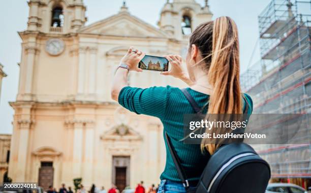 young tourist woman taking photos in mdina, malta - mdina stock pictures, royalty-free photos & images