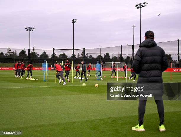 Jurgen Klopp manager of Liverpool watching his players during a training session at AXA Training Centre on February 13, 2024 in Kirkby, England.