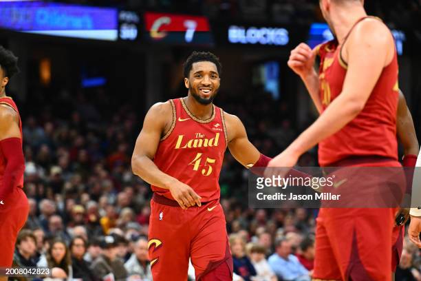 Donovan Mitchell of the Cleveland Cavaliers celebrates with teammates during the fourth quarter against the Philadelphia 76ers at Rocket Mortgage...