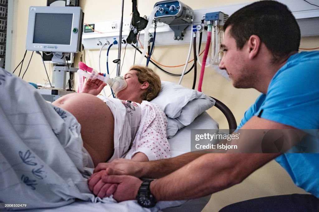 Husband as helping hand in delivery room.