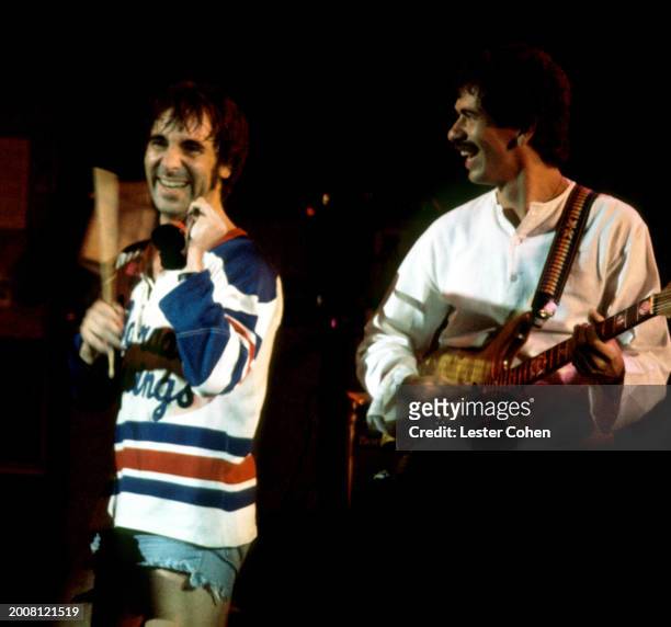 English drummer Keith Moon , from the English rock band The Who, stands on stage with Carlos Santana during an Eric Clapton concert circa 1975 at the...
