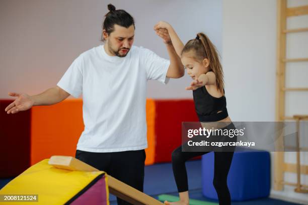 happy girl during corrective gymnastics - little kids doing gymnastics stock pictures, royalty-free photos & images