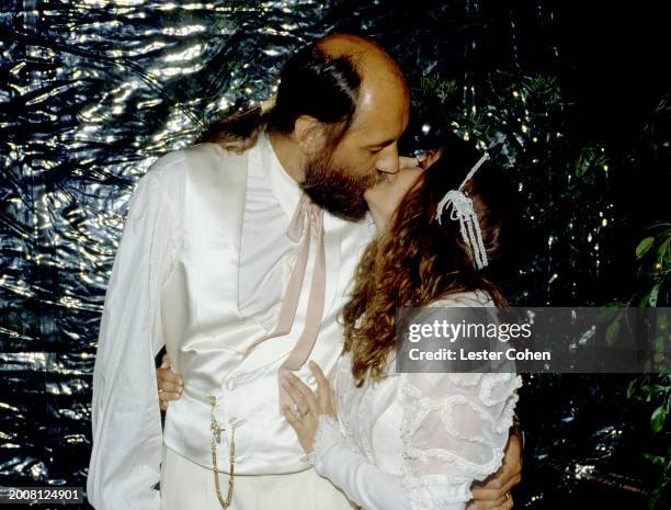 English musician Mick Fleetwood, of the British-American rock band Fleetwood Mac, kisses his new bride Sara Recor during their wedding in Malibu,...