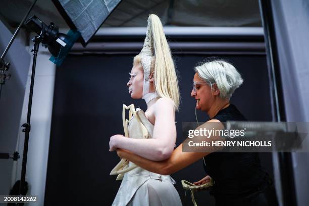 Costume designer Syban Velardi-laufer helps Albino and non-binary model Nan M, represented by Zebedee talent agency, get dress with one of her...