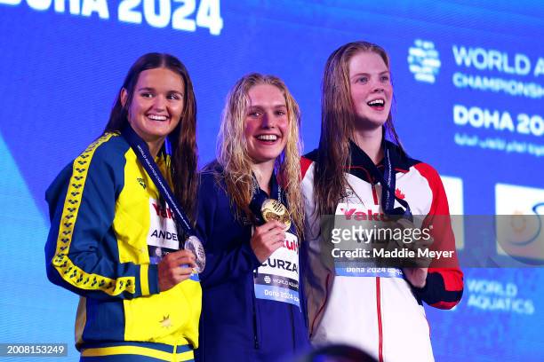 Silver Medalist, Iona Anderson of Team Australia, Gold Medalist, Claire Curzan of Team United States and Bronze Medalist, Ingrid Wilm of Team Canada...