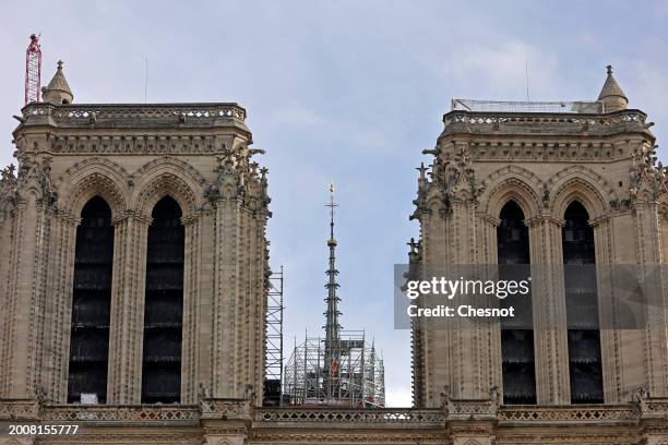 The new golden rooster is seen atop the spire between the two towers of Notre-Dame de Paris cathedral on February 13, 2024 in Paris, France. The...