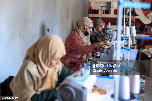 Palestinian women including Meyse Al Qutati , director of the Vocational Training Center in Rafah, produce diapers from cotton and fabric in her...