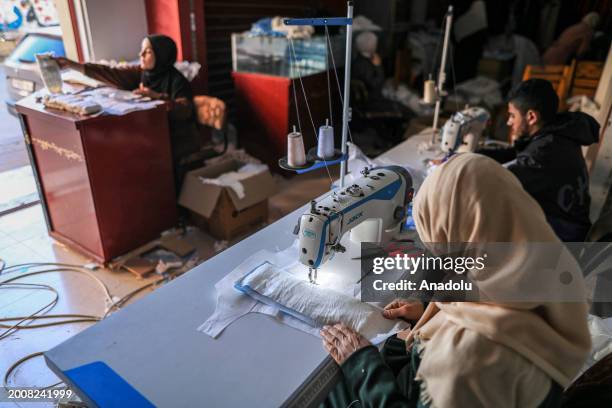 Palestinian women including Meyse Al Qutati , director of the Vocational Training Center in Rafah, produce diapers from cotton and fabric in her...