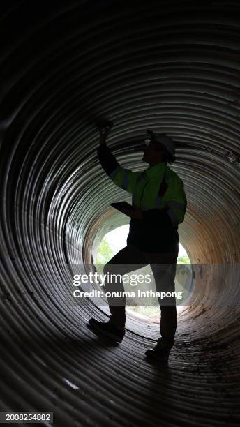 the specialist infrastructure works at modern water supply and sewerage systems. underground pipeline works. water supply and wastewater disposal of a residential city. close-up of underground utilities - väg och vattenbyggnadsingenjör bildbanksfoton och bilder
