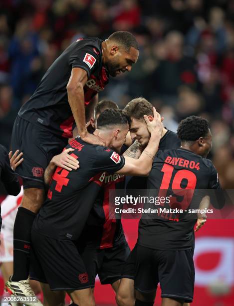 Josip Stanisic of Bayer Leverkusen celebrates as he scores the goal 1:0 with Jonathan Tah of Bayer Leverkusen and Granit Xhaka of Bayer Leverkusen...