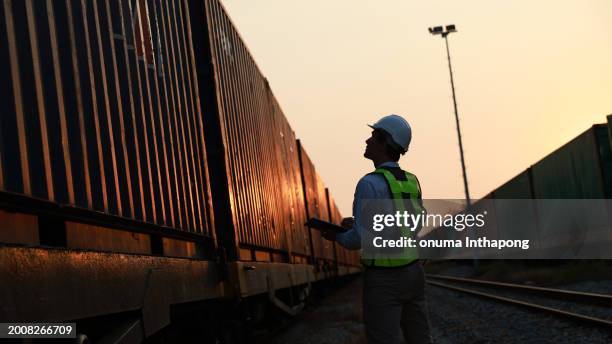 logistic engineer work on container cargo by train freight ship import export, foreman control industrial container cargo freight ship, business people transport container in warehouses at train station - comboio de mercadorias imagens e fotografias de stock