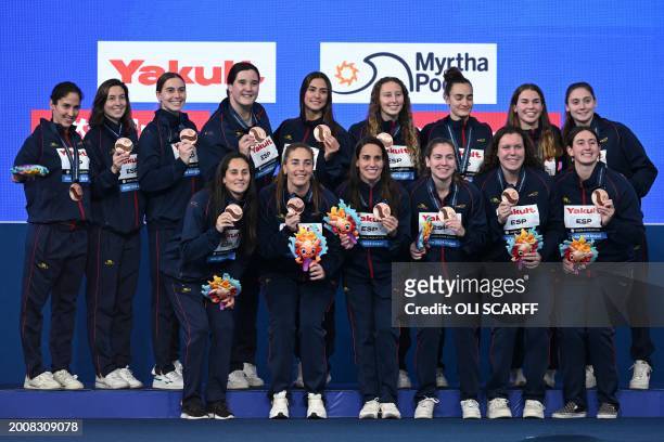 Bronze medallists Spain pose on the podium of the water polo tournament at the 2024 World Aquatics Championships in Doha on February 16, 2024.