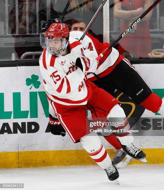 Sam Stevens of the Boston University Terriers checks Pito Walton of the Northeastern Huskies during the first period during NCAA mens hockey in the...