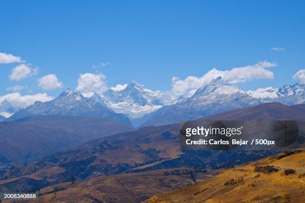 scenic view of snowcapped mountains against blue sky - viajes stock pictures, royalty-free photos & images