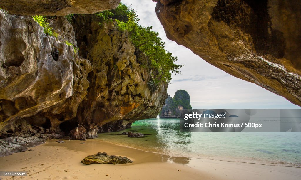 Scenic view of rock formation in sea against sky