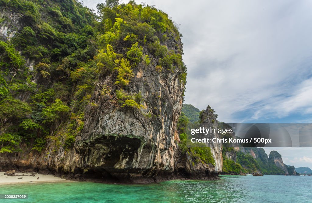 Scenic view of rock formation in sea against sky
