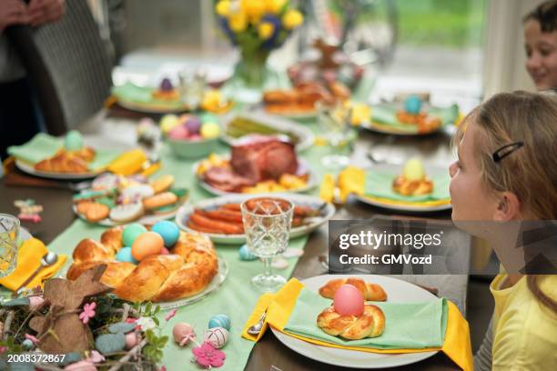 easter lunch with roast pork, vegetables, easter cookies and easter cake - decorating a cake stock pictures, royalty-free photos & images
