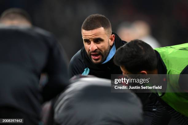 Kyle Walker of Manchester City speaks with teammates during the warm up prior to the UEFA Champions League 2023/24 round of 16 first leg match...