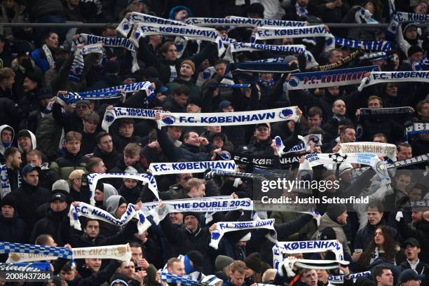 Fans of FC Copenhagen show their support as they hold scarves prior to the UEFA Champions League 2023/24 round of 16 first leg match between F.C....