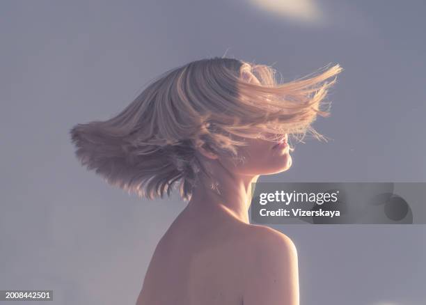portrait of young woman with flying hair - bobbed hair stock pictures, royalty-free photos & images