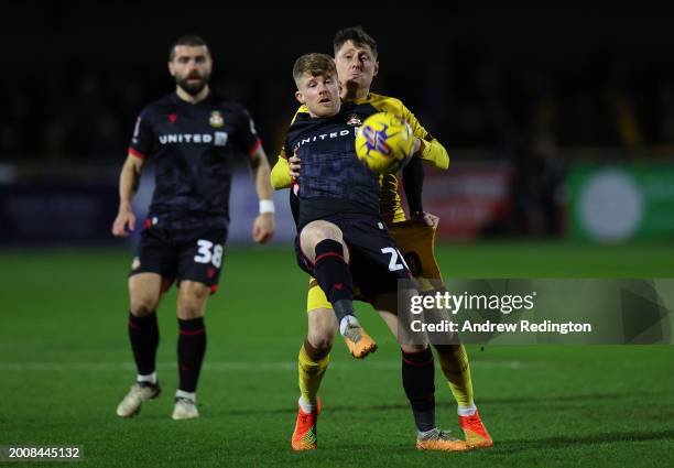 Andy Cannon of Wrexham wins the ball ahead of Harry Beautyman of Sutton United during the Sky Bet League Two match between Sutton United and Wrexham...