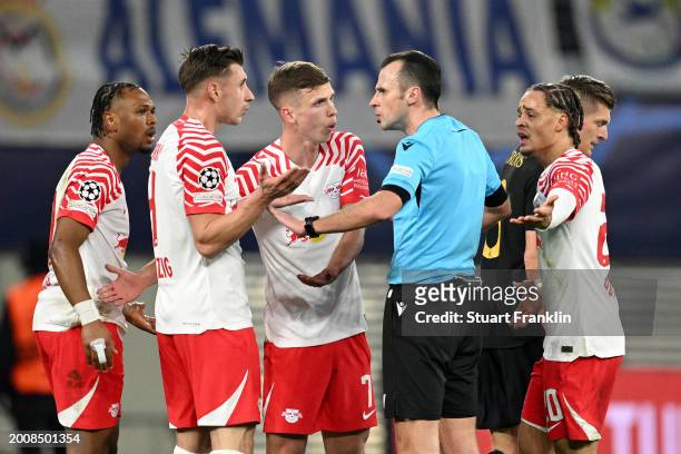 Referee Irfan Peljto interacts with the players of RB Leipzig during the UEFA Champions League 2023/24 round of 16 first leg match between RB Leipzig...