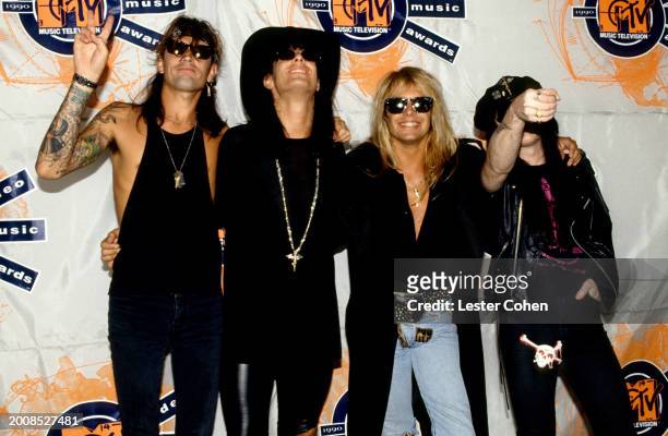 American musicians Tommy Lee, Nikki Sixx, Vince Neil and Mick Mars, of the American heavy metal band Mötley Crüe, pose for a group portrait backstage...
