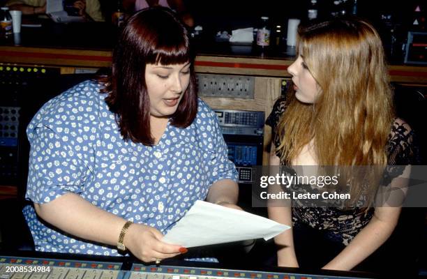 American singers Carnie Wilson and Wendy Wilson, of the American pop vocal group Wilson Phillips, talk in the recording studio in Los Angeles,...