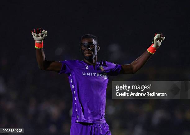 Arthur Okonkwo of Wrexham celebrates his side's first goal whilst wearing a protective face mask during the Sky Bet League Two match between Sutton...