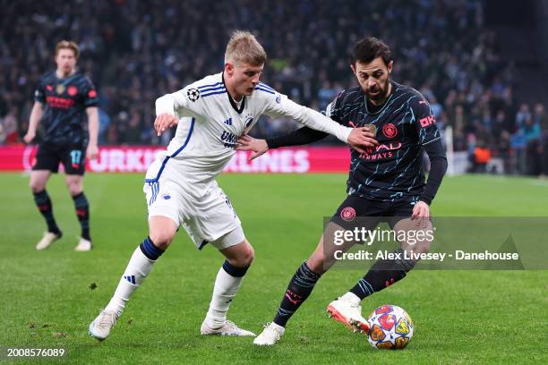 Bernardo Silva of Manchester City battles for possession with Magnus Mattsson of Copenhagen during the UEFA Champions League 2023/24 round of 16...