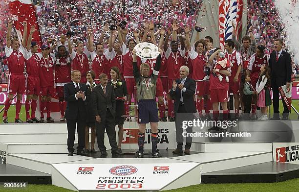 Captain Oliver Kahn of FC Bayern Munich holds the trophy aloft as players celebrate winning The Bundesliga match between FC Bayern Munich and VFB...
