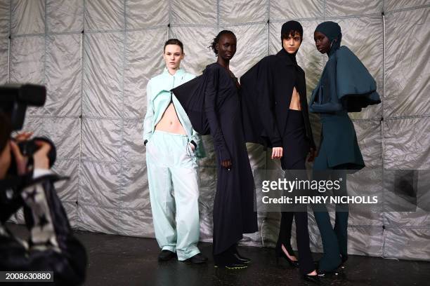 Models pose back-stage ahead of the catwalk presentation by Fashion East for their Autumn/Winter 2024 collection, during London Fashion Week in...